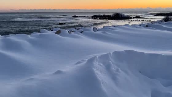 Peaceful sunrise reveals snow-covered coast after nor’easter in Ogunquit, Maine, USA