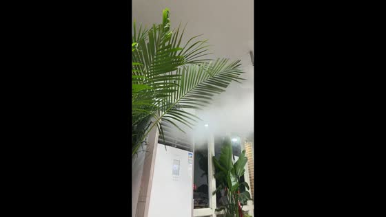 Ceiling fan circulates thick mist from floor AC in restaurant in Shanxi, China