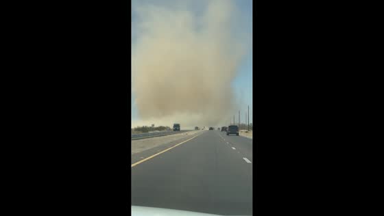Dust devil crosses busy highway in San Tan Valley, Arizona, USA