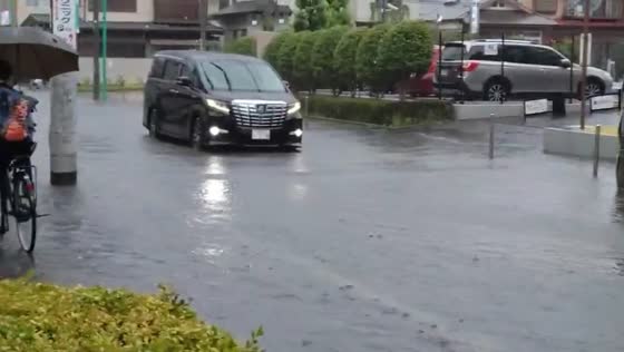 Flooded roadway slows traffic on Route 283 in Ichikawa, Chiba, Japan