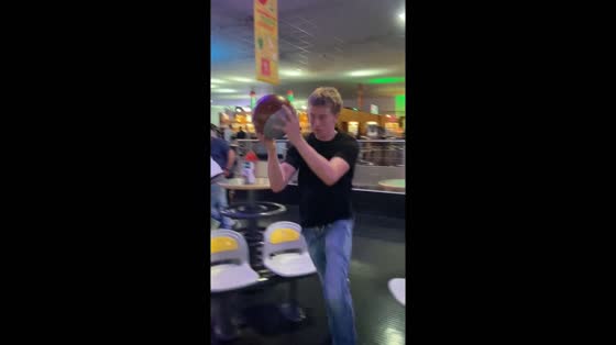 Friend attempts creative bowling shot in Mulhouse, France