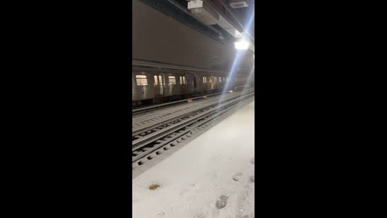 Train passes station as sparks appear beneath railcar in New York, USA