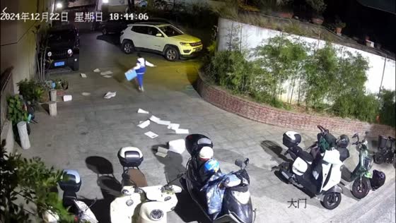 Boy chases scattered papers in windy Fujian, China