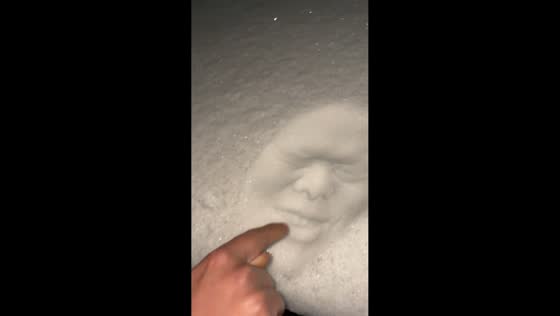 Man makes face imprint in snow and laughs at result in Hebei, China