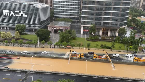 Typhoon Dussuri aftermath: government trucks extracting water from flooded road tunnel in Fuzhou, Southeast China