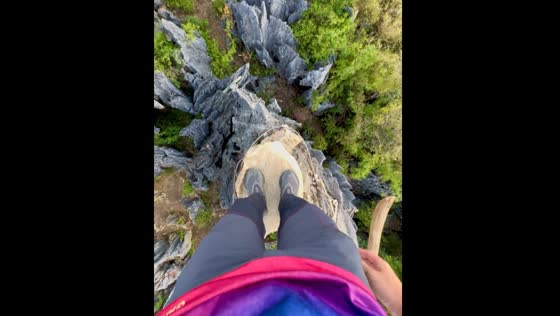Person climbs a narrow rock in Rodriguez, Rizal