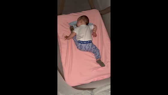 Baby sleeping soundly in funny position in New York, USA