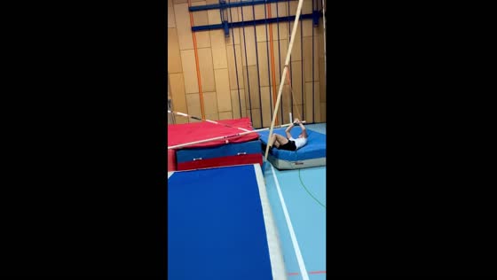 High jump mishap: pole vaulter misses landing zone, lands safely on side cushion