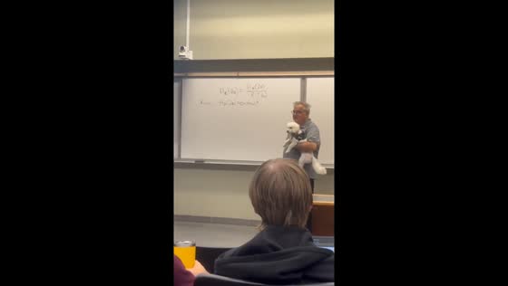 Teacher carries dog while teaching in Shanghai, China