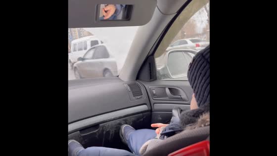The child rubs his dirty shoe into his dad's car compartment.
