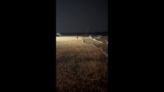 Man playfully jumps over strong waves at night in Khon Kaen, Thailand
