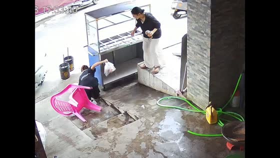 Woman topples sideways after chair slips off pavement in Hainan, China