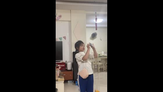 Girl plays with parrot using hand gestures in Hunan, China