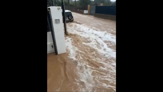 Rising floodwaters in streets threaten vehicles and homes in Ibiza, Spain