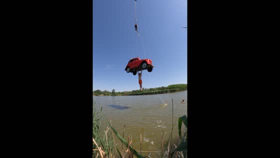 Man holds onto suspended car until plunging into water in Rostov-on-D