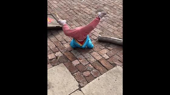 Child falls while jumping stairs then does a trick roll and gets up