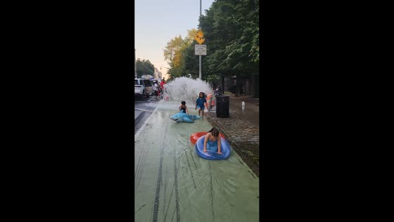 Kids float through DIY street water park in Manhattan, New York