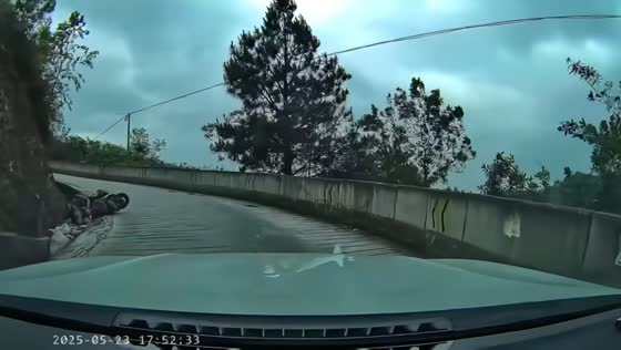 Motorcycle mishap on curve road in Guangxi, China