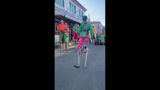 Stilt performer performs somersault to pick up box in Hebei, China