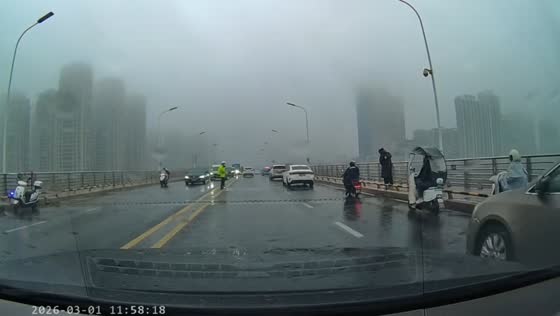 Man pulls person away from bridge railing during heavy rain in Anhui, China
