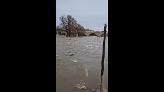 Regensburg's Stone Bridge battling raging flood waters