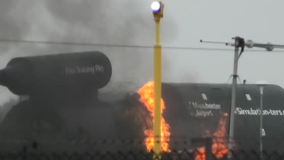 Airport fire crews carry out aircraft fire-training exercise at Manchester Airport, UK
