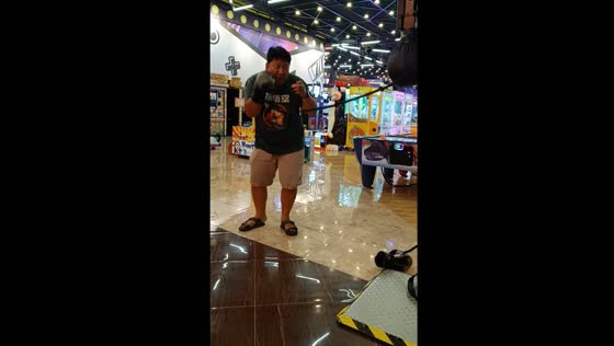 Person slips and falls while attempting punching machine in Yogyakarta, Indonesia