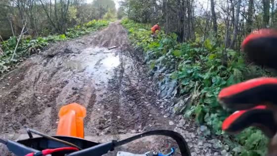 Motorcyclist loses balance on muddy forest road in Saint Petersburg, Russia 