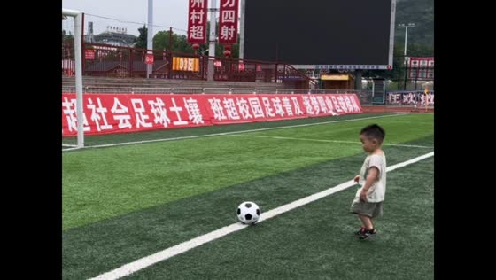 Boy slips over soccer ball while trying to kick it in Guizhou, China