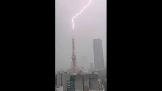 Lightning strikes Tokyo Tower during storm in Minato, Tokyo, Japan