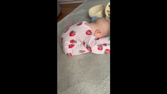 Baby falls asleep in funny folded position in Wrexham, Wales, UK