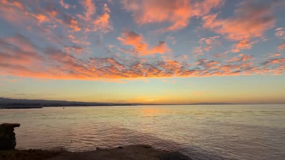 Vibrant sunrise illuminates Monterey Bay near Santa Cruz, USA