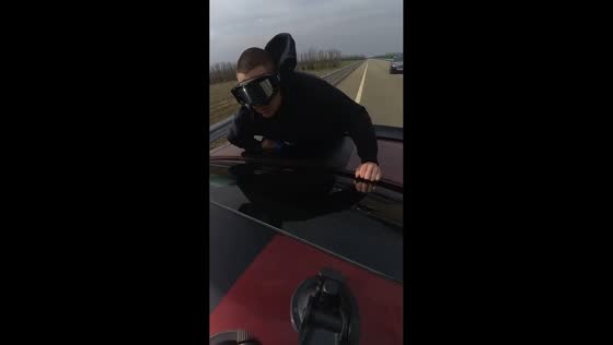 Man performs push-up challenge between two moving cars in Rostov-on-Don, Russia