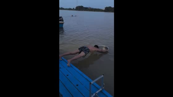 Man performs plank exercise using floating metal bowl in Guangdong, China