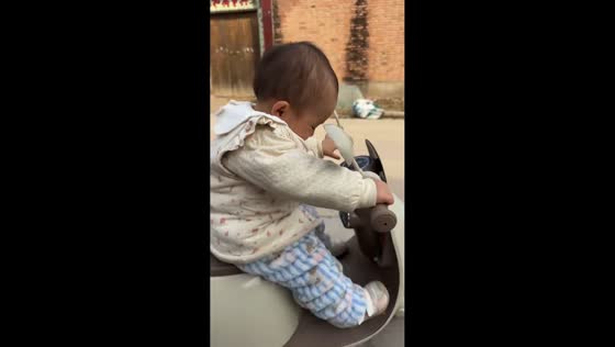 Baby learns to ride balance bike in Henan, China