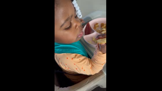 Determined diner: toddler rejects sleeve help in adorable standoff