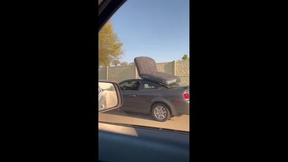 Car with air mattress tied on roof in fast pace in Columbus, Ohio