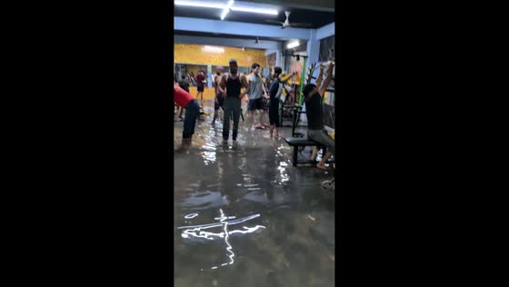 Gym-goers continue exercising in flooded gym in Gurgaon, India