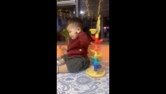 Baby enjoys spiral ramp toy with rhythmic sounds in Xinjiang, China 