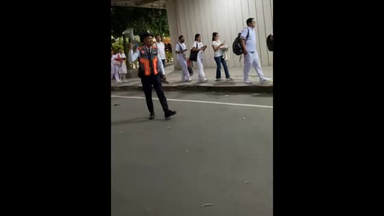 Guard lifts spirits of nursing board exam takers outside MCU in Caloocan, Philippines