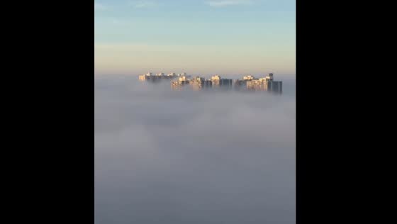 Bangalore skyline appears above the clouds