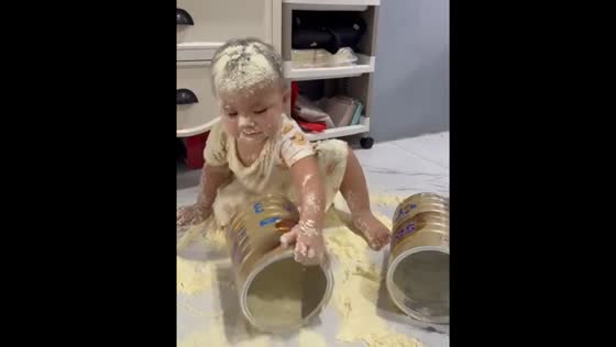 Child plays with spilled baby formula in Manado