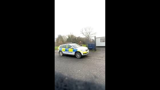 Motorbike rider throws dirt on police vehicle in Belfast, Ireland