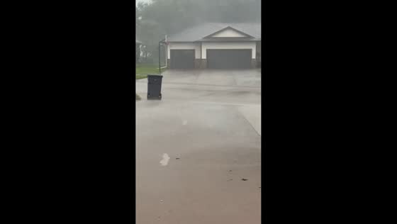 Heavy downpour and wind blur visibility in Norfolk, Nebraska