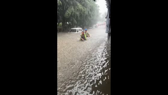 Waist-deep floodwater inundates roadway during heavy rain in Sichuan, China