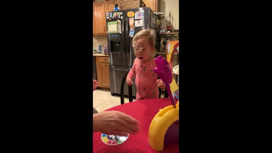 Toddler gets whipped cream in the face during Pie Face game in Magnolia, USA
