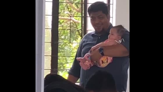 Professor helps student care for baby during exam in Catbalogan, Philippines