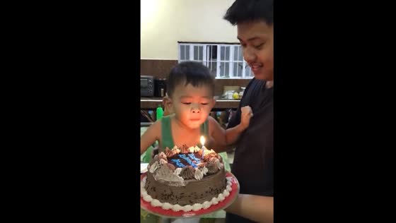 Three-year-old Carlo rushes through birthday song to blow out a candle
