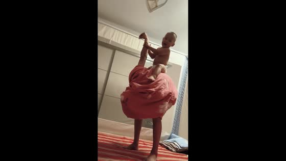 Baby enjoys playful "ostrich ride" illusion in Hebei, China
