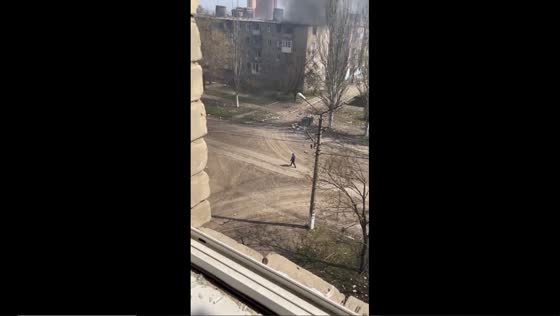 Unfazed: a man's daring walk amidst shelled buildings in Bakhmut, Ukraine